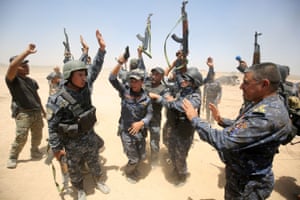 Pro-government forces fighters celebrate in al-Sejar village as they take part in a major assault to retake the city of Fallujah.