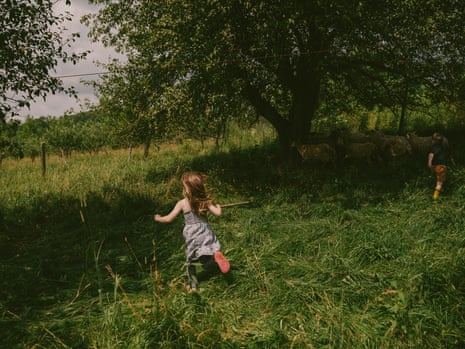 Two kids running in a field