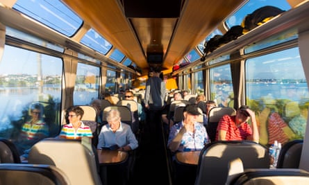 People sitting inside the scenic Northern Explorer train going between Auckland and Wellington,