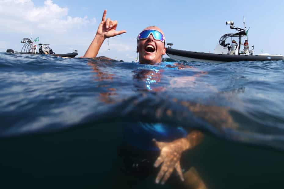 Emma Wilson of Team Great Britain celebrates in the water after winning bronze in the Women’s RS:X windsurf class.