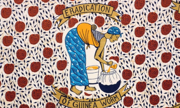 A fabric from Togo depicts a woman filtering water to prevent Guinea worm.