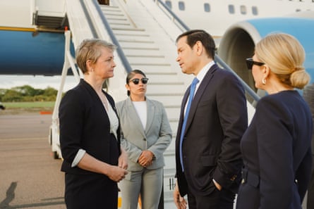 Yvette Cooper converse beside the steps leading up to an aeroplane.