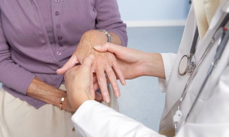 Woman's hands are examined by a doctor