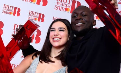 Dua Lipa (L) with her awards for Best British Female Solo Artist and Breakthrough Act and Stormzy with his British Album of the Year and British Male Solo Artist awards.