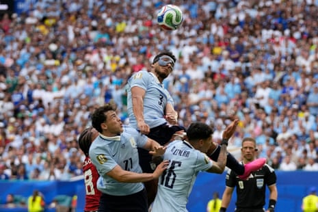 Uruguay's Sebastian Caceres heads clear.
