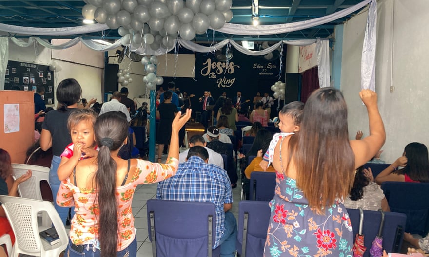 people wave and celebrate in small church