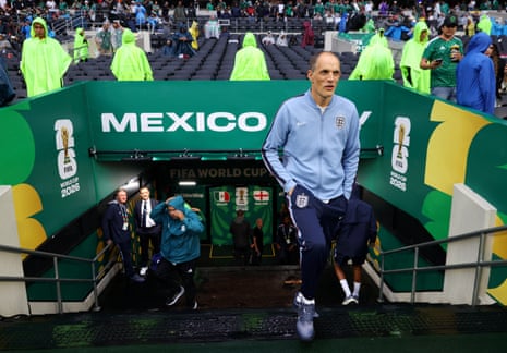 Thomas Tuchel walks out of the tunnel as the rain falls
