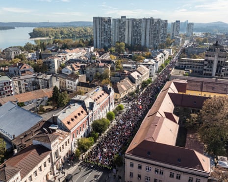 A long train of people marching down a street