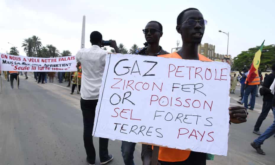 Protesters hold banners calling for greater transparency in the oil industry at a march in Dakar, Senegal.