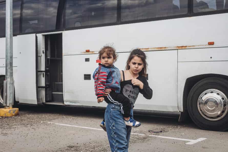 A young girl clutches a small child arriving in Zaporizhzhia, Ukraine, on Tuesday,