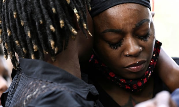 Letetra Wideman and Zanetia Blake, sisters of Jacob Blake, a Black man who was shot several times in the back by a police officer, embrace outside the Kenosha County Courthouse in Kenosha, Wisconsin.
