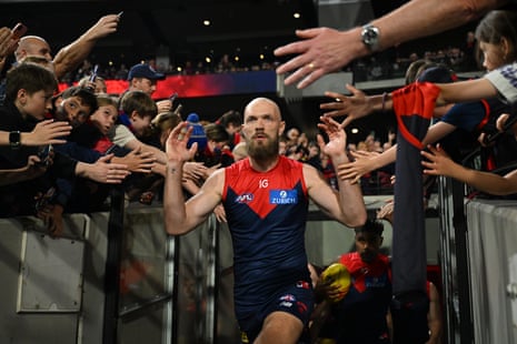 Max Gawn high fives fans as he walks out of the tunnel