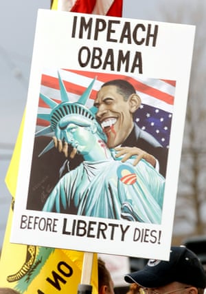 A Tea Party supporter holds an anti-Obama sign at a rally in Clinton Township, Michigan, in April 2010.
