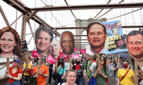 Abortion rights protesters in New York carry pictures of the conservative-leaning supermajority members of the US supreme court bench, from right, John Roberts, Samuel Alito, Clarence Thomas, Neil Gorsuch, Brett Kavanaugh and Amy Coney Barrett. In 2022 after a draft opinion was leaked showing the court would overturn Roe v Wade.