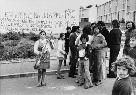 Residents of Lisbon’s Boa Vista district stand in front of a building sprayed with slogans of the Portuguese Workers’ Communist party shortly after the revolution.
