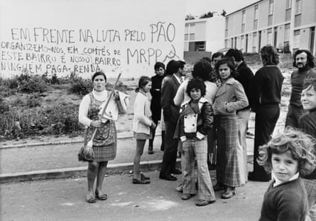 Residents of Lisbon’s Boa Vista district stand in front of a building sprayed with slogans of the Portuguese Workers’ Communist party shortly after the Carnation Revolution.