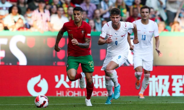 Adam Hlozek chases Portugal's João Cancelo in a Nations League match.