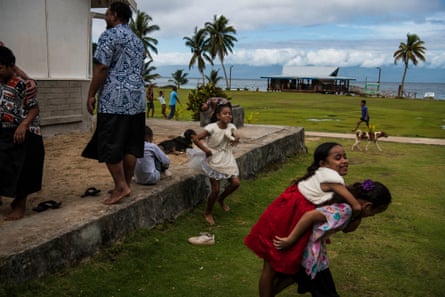 Children play on Kioa after church service