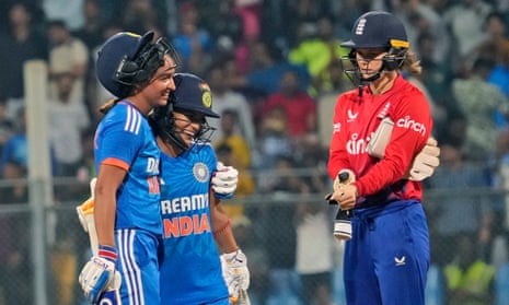India’s captain Harmanpreet Kaur, left, celebrates with teammate Amanjot Kaur as England’s Amy Jones looks on.