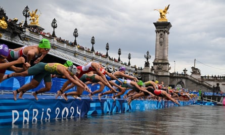 ‘A generational baton-change’ … triathletes dive into the Seine during the Paris Olympics.