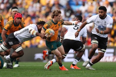 Tate McDermott of the Wallabies is tackled.