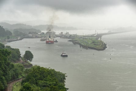 A tug helps a vessel navigate safely into the Pedro Miguel Locks near Paraiso, Panama.