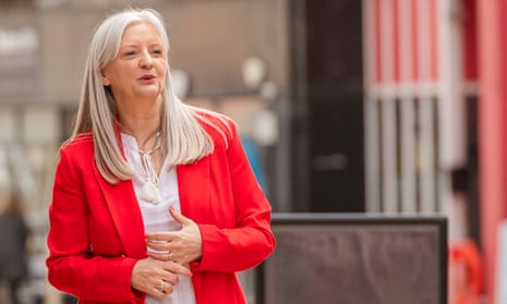 Wilma Brown photographed outdoors in a Kirkcaldy street: she has long, straight blond hair and is wearing a white shirt and bright red jacket