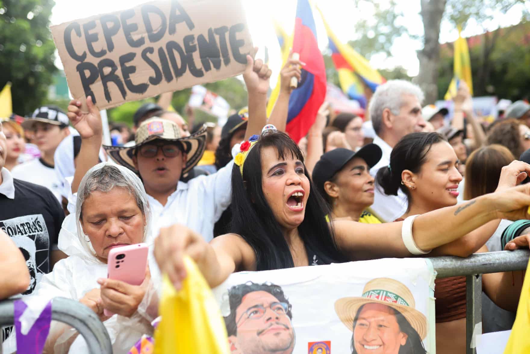 A crowd of people, one of the holding up a cardboard sign reading ‘Cepeda president’