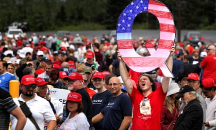 David Reinert holds up a ‘Q’ while waiting to see Donald Trump at a rally on 2 August 2018 in Wilkes Barre, Pennsylvania.