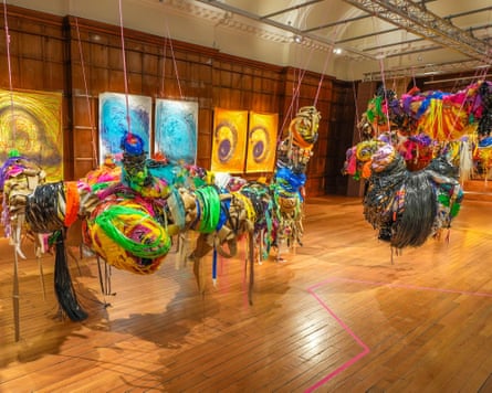 Colourful installations hanging from ceiling and paintings on wall