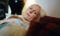 Laura Marling relaxing on a sofa with the top of her daughter's head just visible beside her.