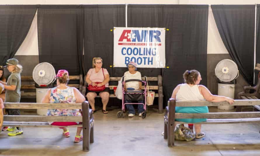 People sit inside a cooling booth at the Shasta district fair during a heatwave in Anderson, California, on 26 June 2021.