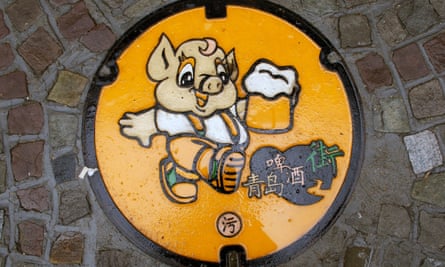 A humorous manhole cover near the Tsingtao brewery in Qingdao, China.