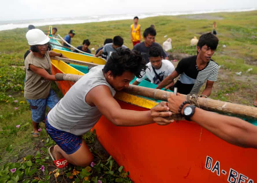 Villagers secure a boat in Aparri, Cagayan province.