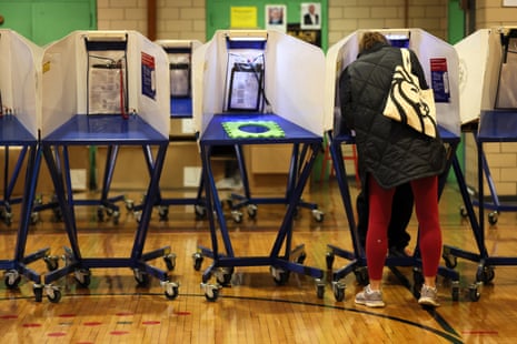 a person stands in a voting booth