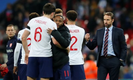 Harry Maguire, left, and Raheem Sterling embrace after defeating the Czech Republic.