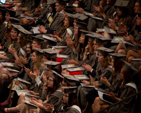 Young graduates wearing rented gowns and mortarboards applaud a speech at the University of York, England