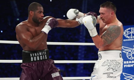 Oleksandr Usyk tussles with Daniel Dubois in their Wroclaw bout in August 2023