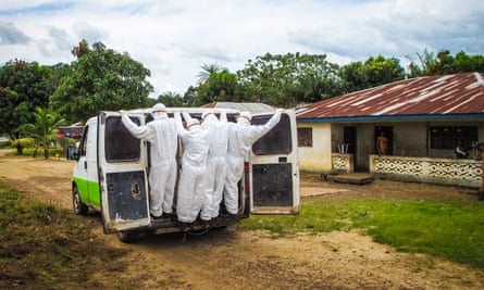 Health workers transport the body of a suspected Ebola victims in Port Loko, on the outskirts of the Serra Leonean capital Freetown, in October 2014