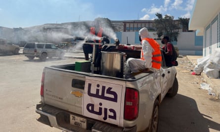 Volunteers disinfect a field hospital in the aftermath of the floods in Derna, Libya.