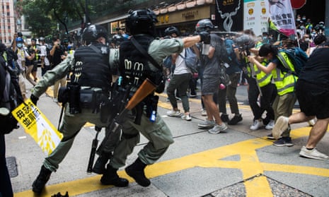 Hong Kong police direct pepper spray towards journalists covering a protests against the Beijing-imposed national security law on Wednesday.