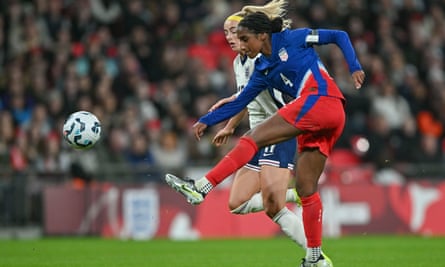 Naomi Girma and Chloe Kelly vie for the ball for their national teams in London in November 2024