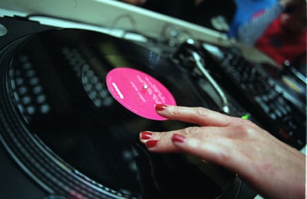 Hand with red nail varnish on vinyl record