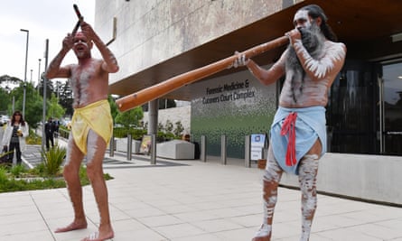 Aboriginal dancers perform outside the inquest before it began on Monday