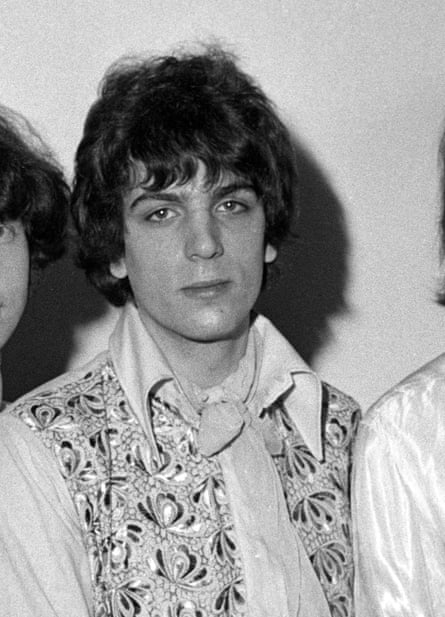 Black and white photo of young man in big-collared shirt and psychedelic waistcoat.