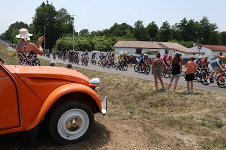 Spectators watch the Tour de France riders pass.