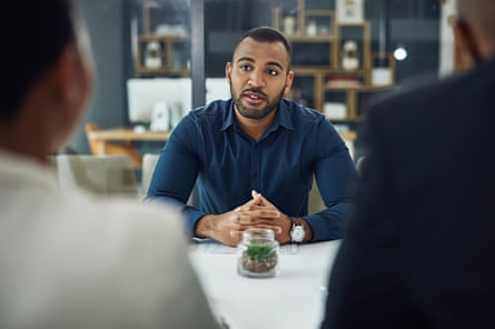 A young businessman sitting being interviewed