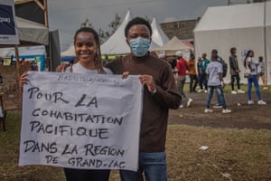 Artists and activists hold banners to raise awareness of security issues in Goma