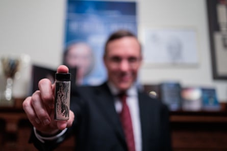 Loeb with a tube containing meteorite fragments recovered from the bottom of the Pacific Ocean.