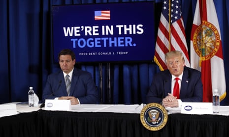 Ron DeSantis and Donald Trump sitting together at a table
